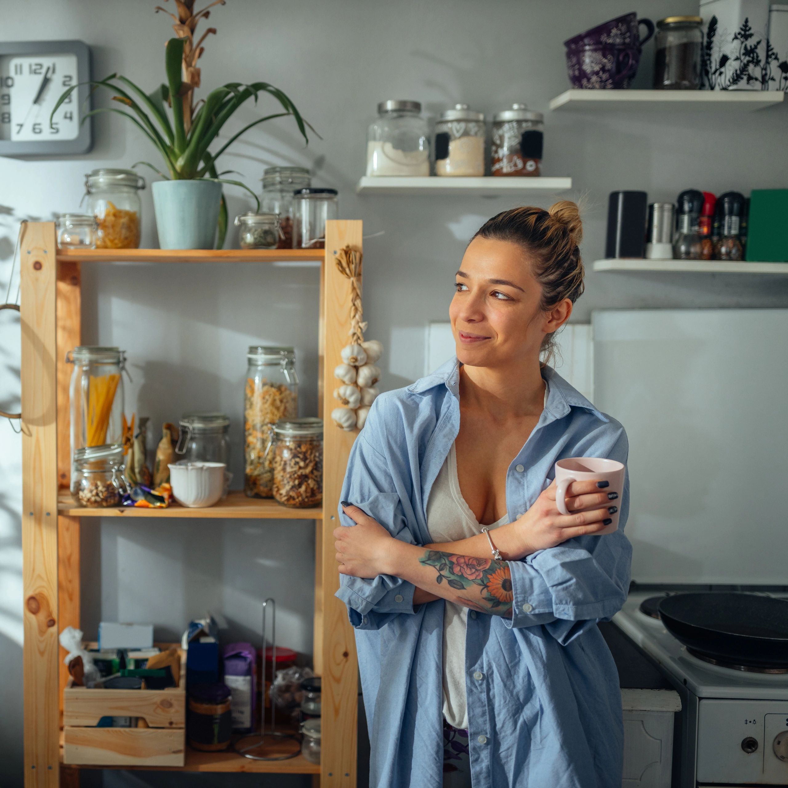 Satisfied homeowner enjoying coffee in kitchen
