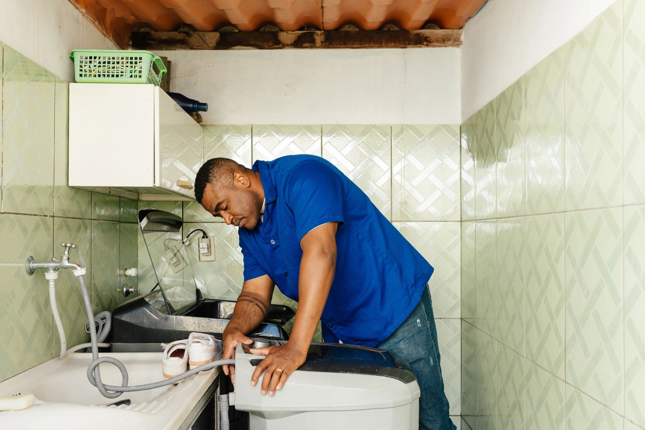 Appliance technician inspecting a washing machine